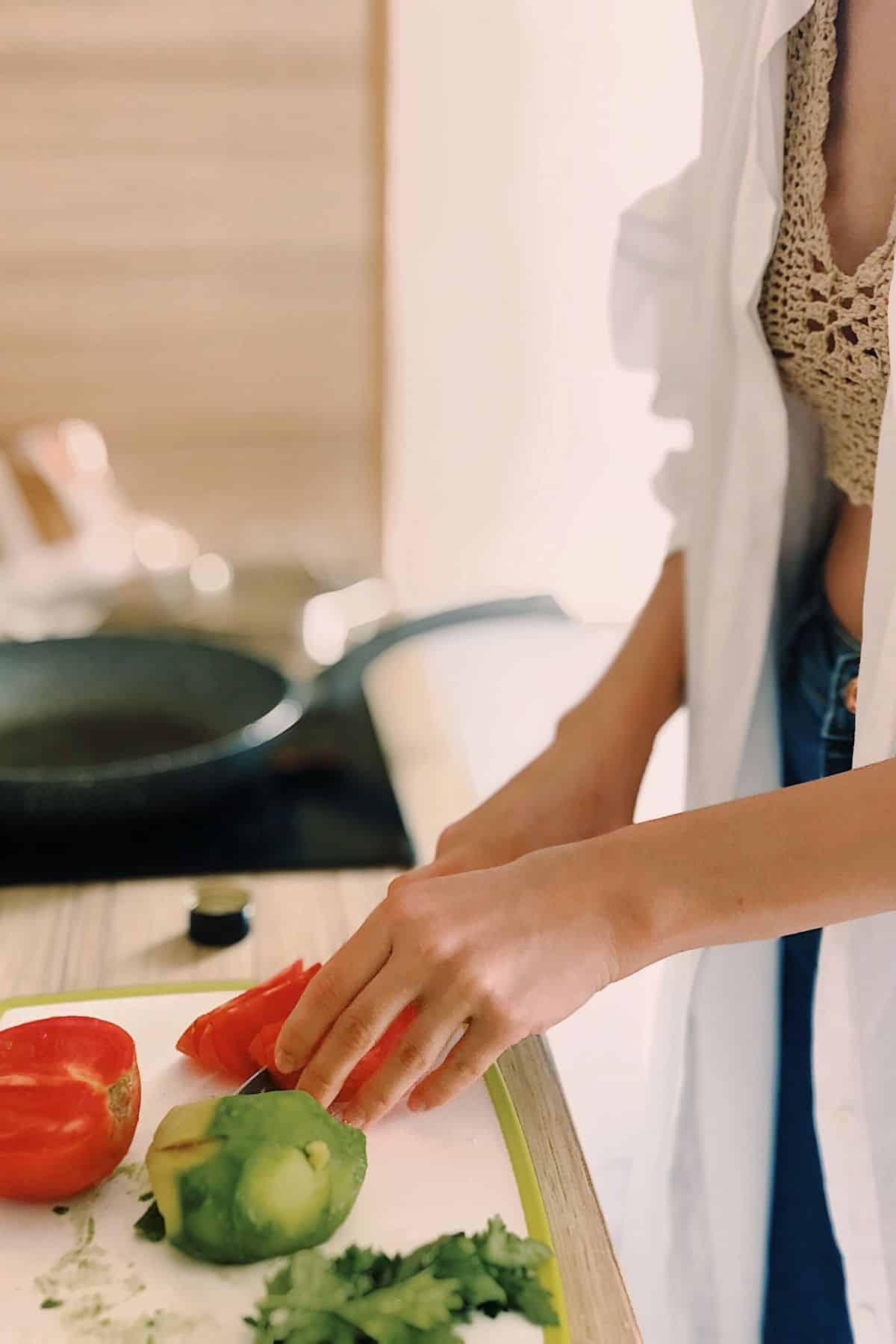 woman chopping veggies in the kitchen.