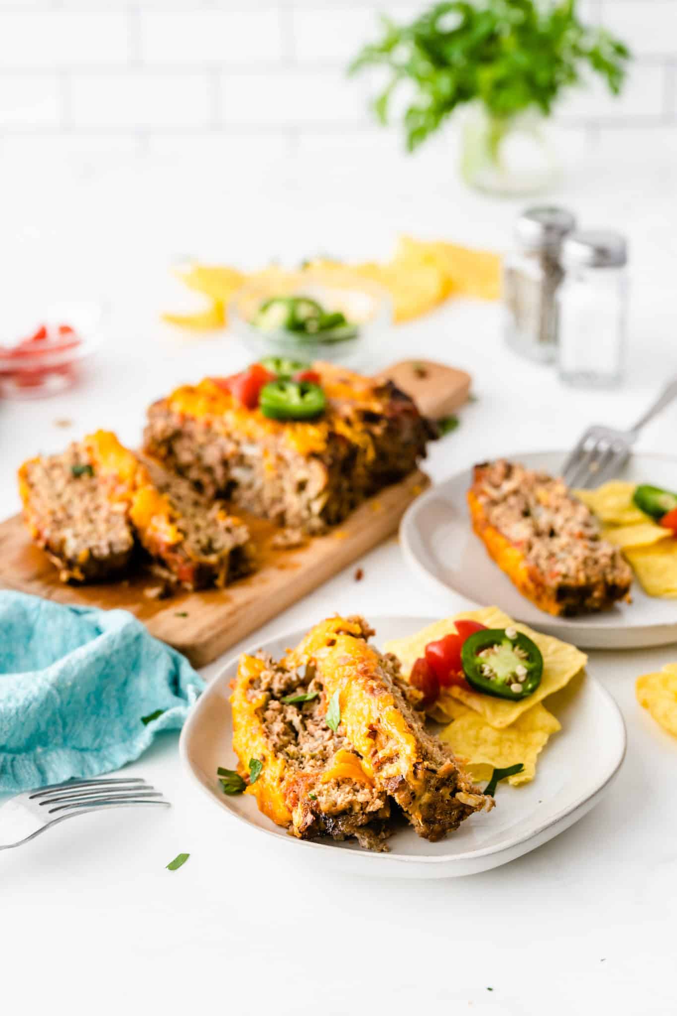 table setting with serving plates of taco meatloaf.