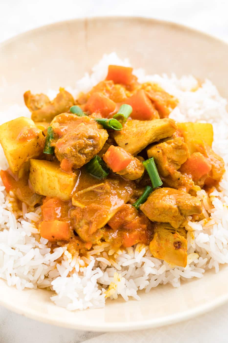 bowl of instant pot chicken curry on top of steamed rice.