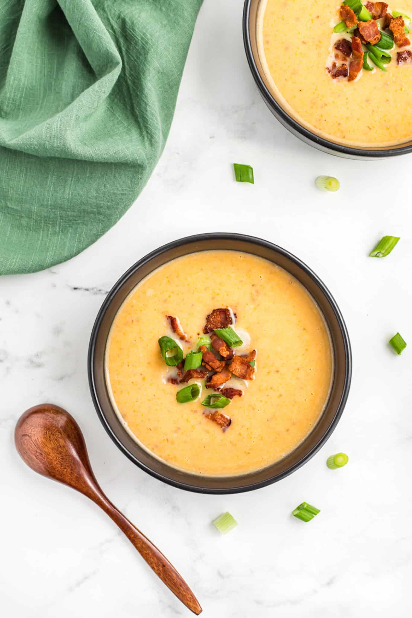 two bowls of potato soup with bacon and scallions.