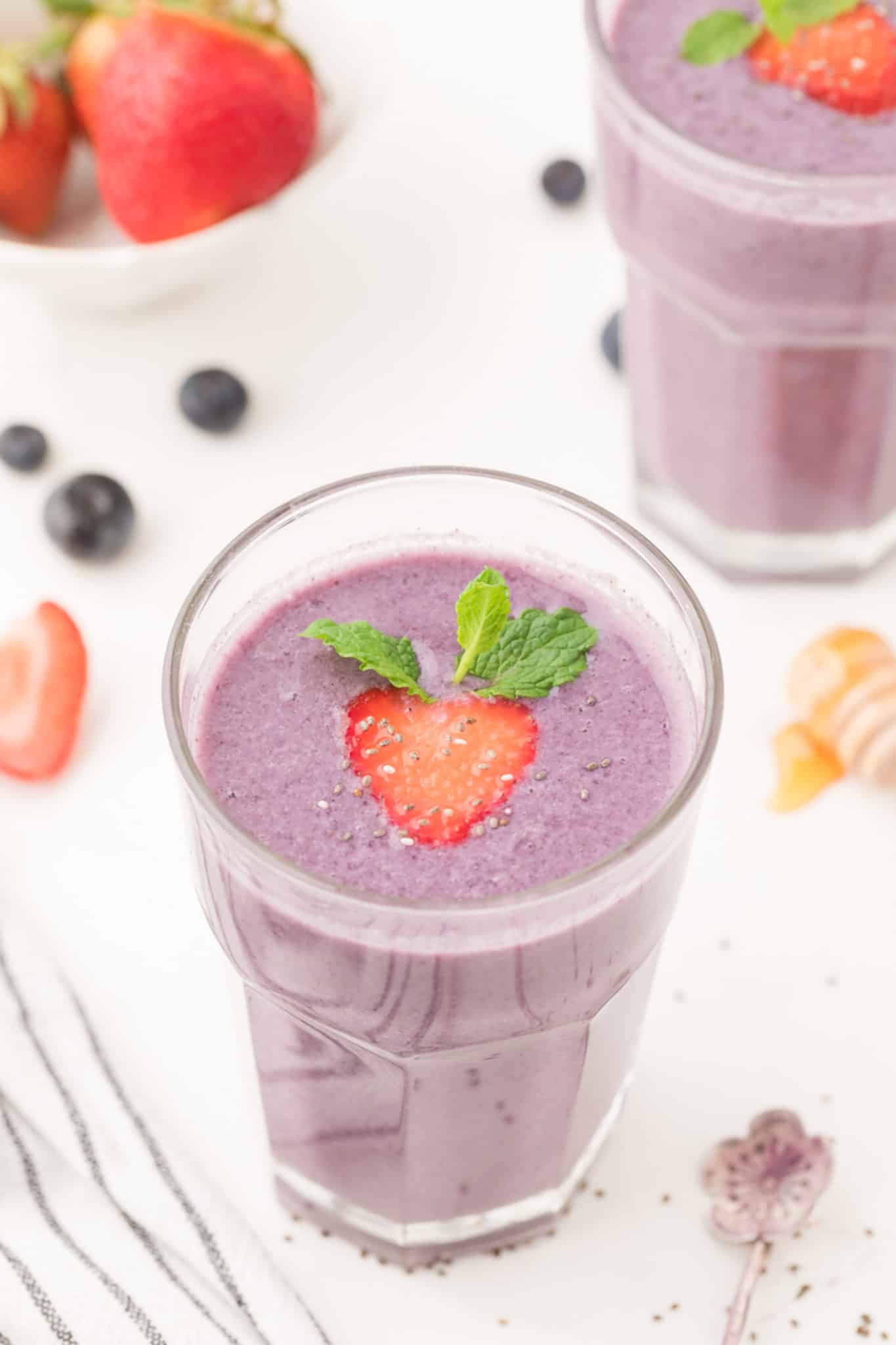 A strawberry blueberry smoothie in a glass.