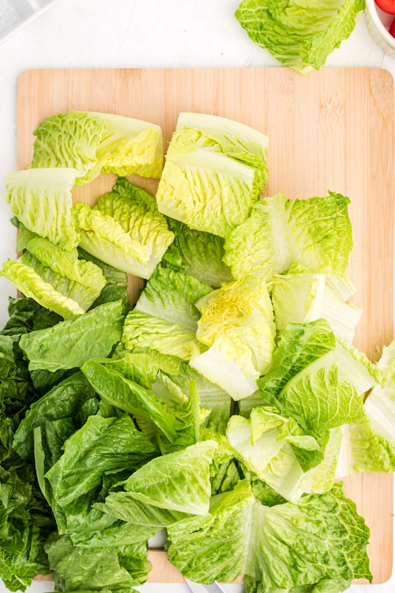 chopped romaine lettuce on a cutting board.