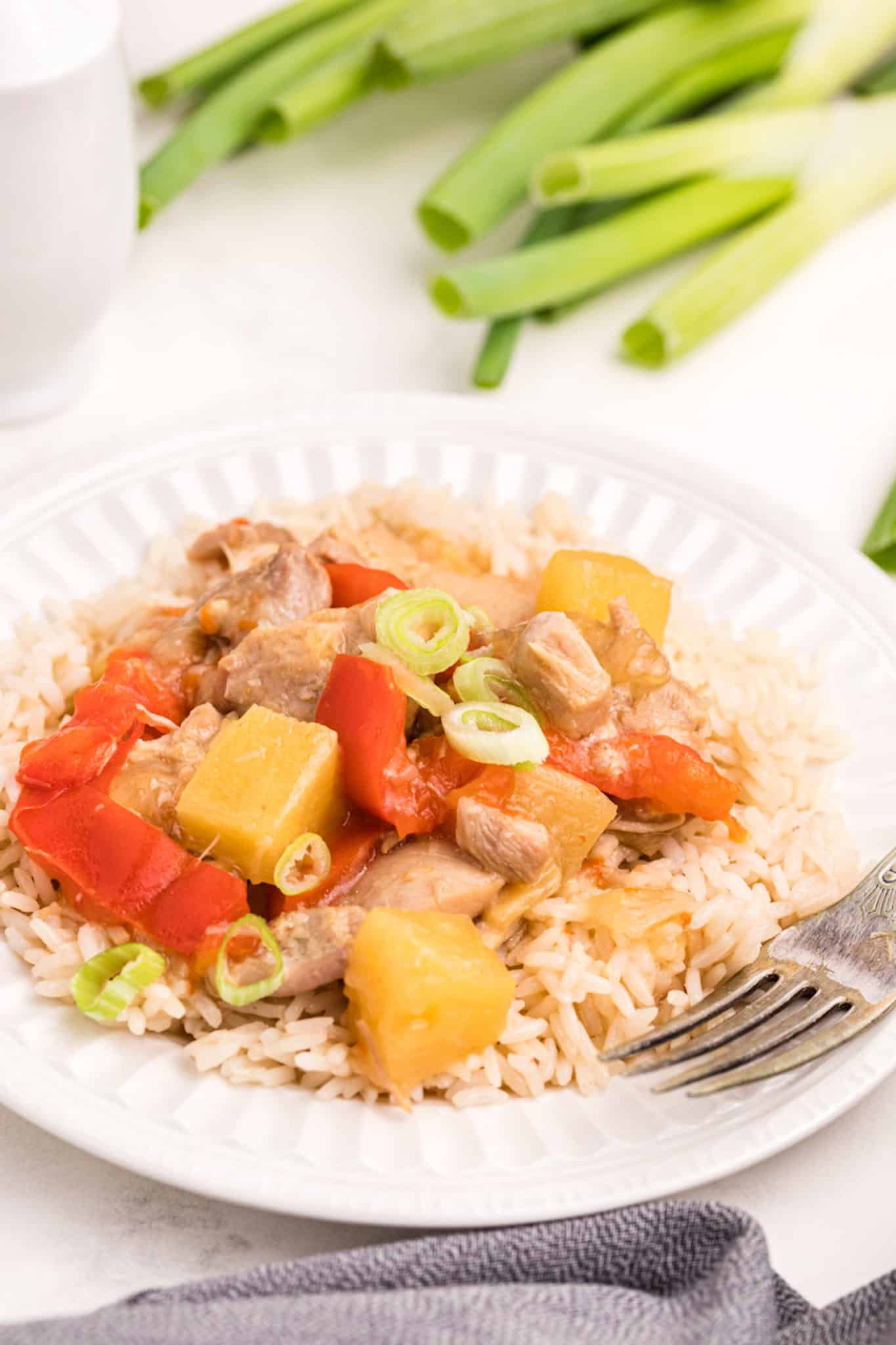 cooked instant pot chicken, pineapple, and rice on a plate.