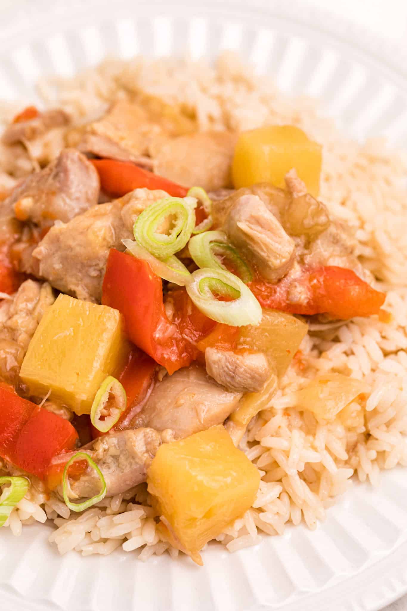 cooked instant pot pineapple chicken with rice on plate.