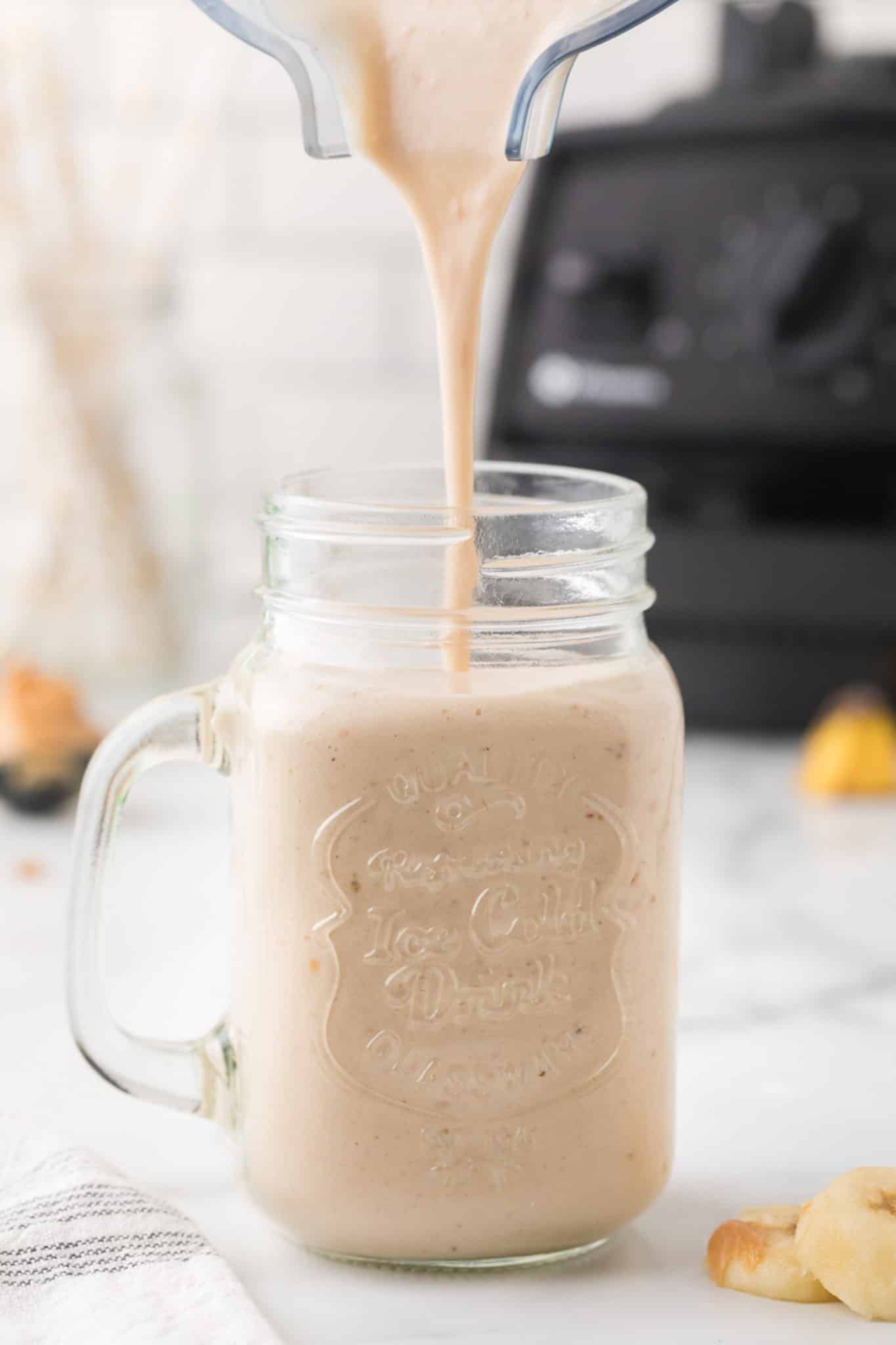 pouring smoothie into glass