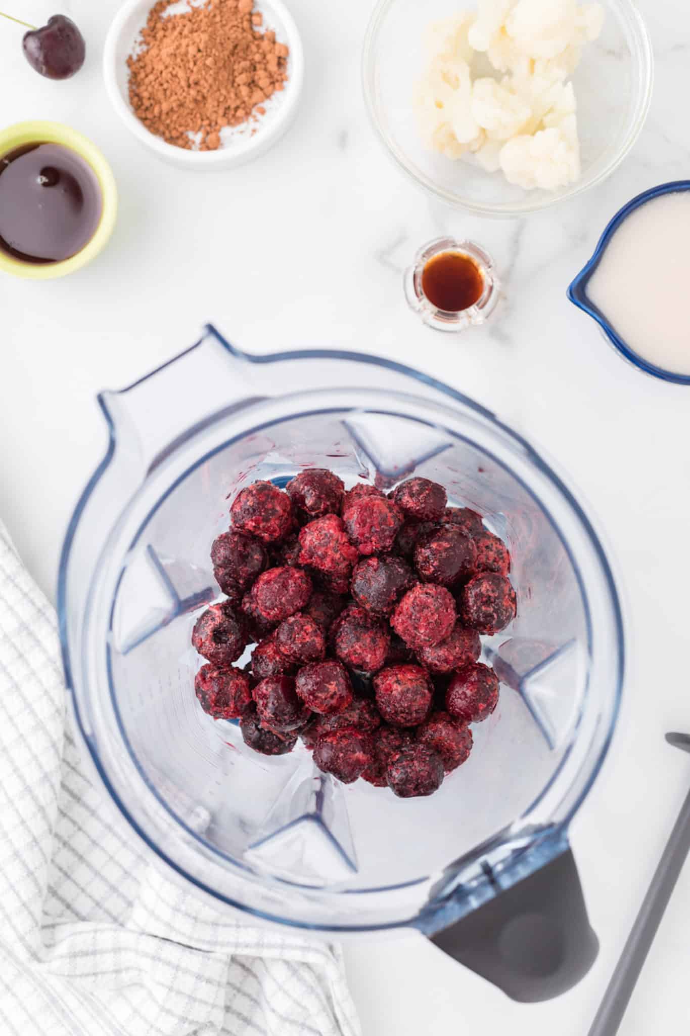 cherries in a blender for cherry chocolate smoothie.