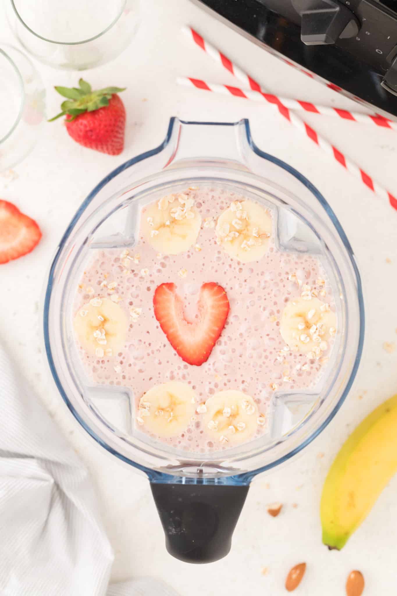 pink smoothie inside of a blender.