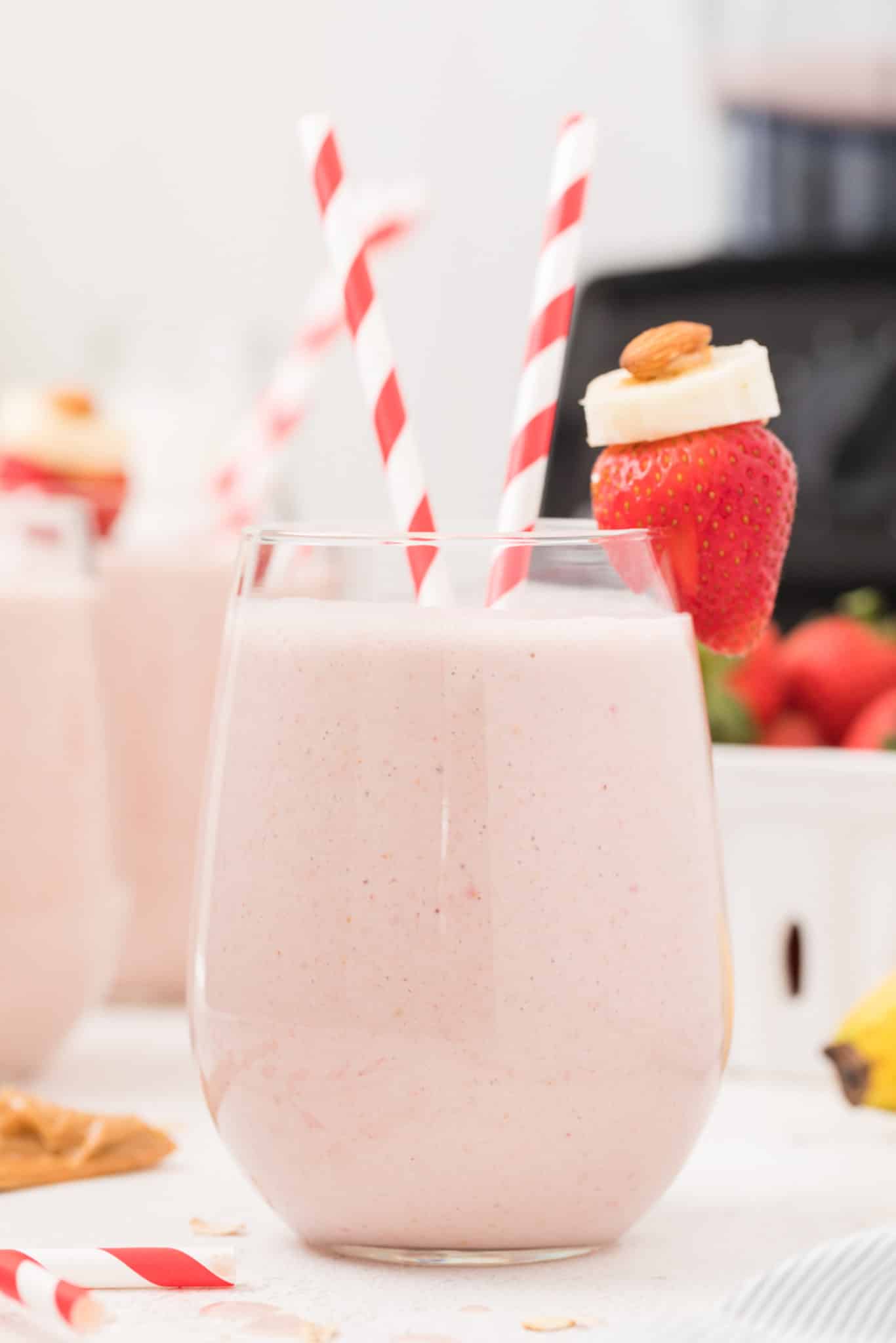 strawberry banana oatmeal smoothie served in a glass on a table.