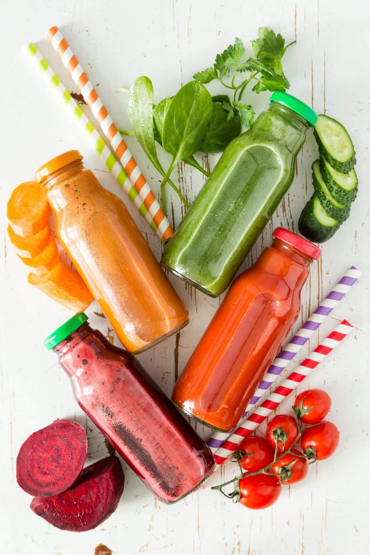 colorful vegetable juices in glass jars on a table.