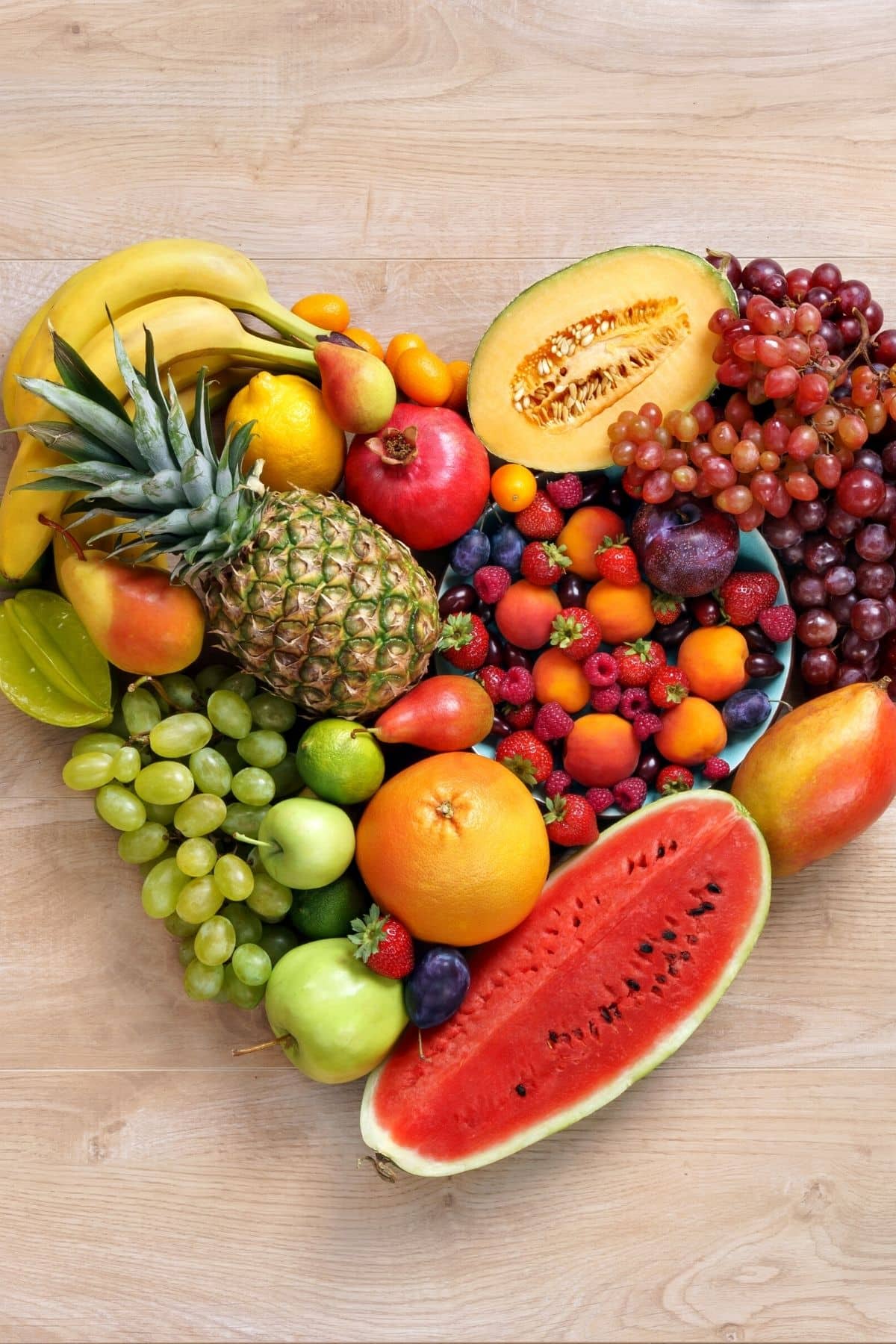 fruits on a table in the shape of a heart