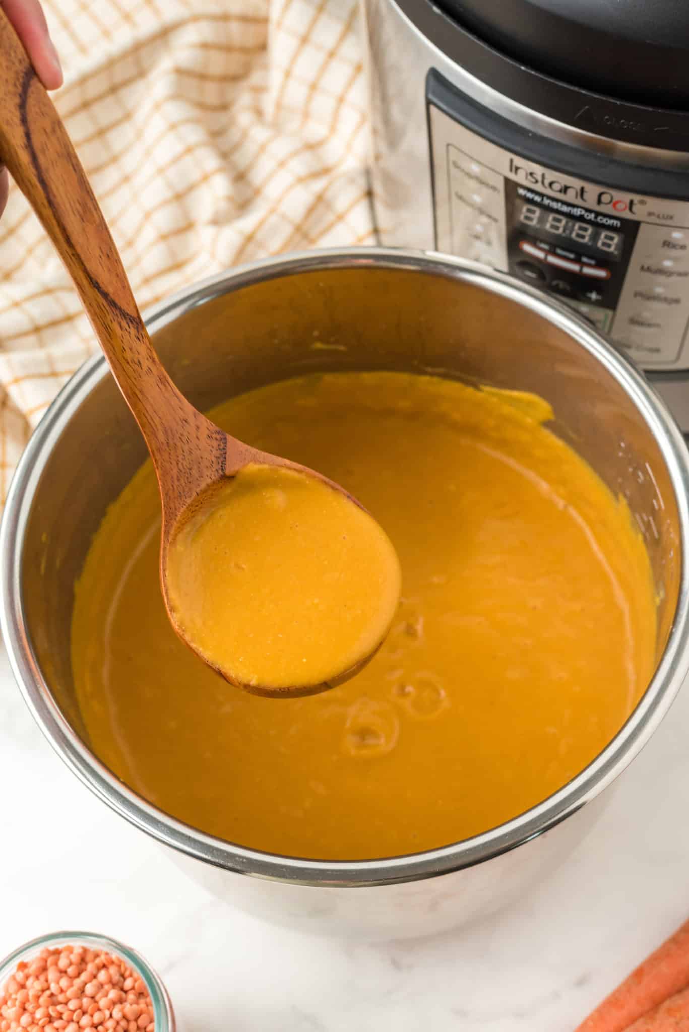 a ladle of soup serving out of instant pot.