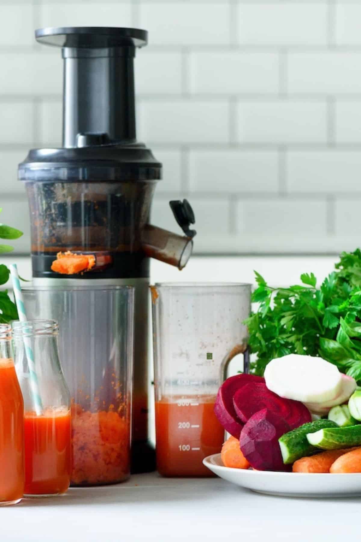 centrifugal juicer on table with vegetables.