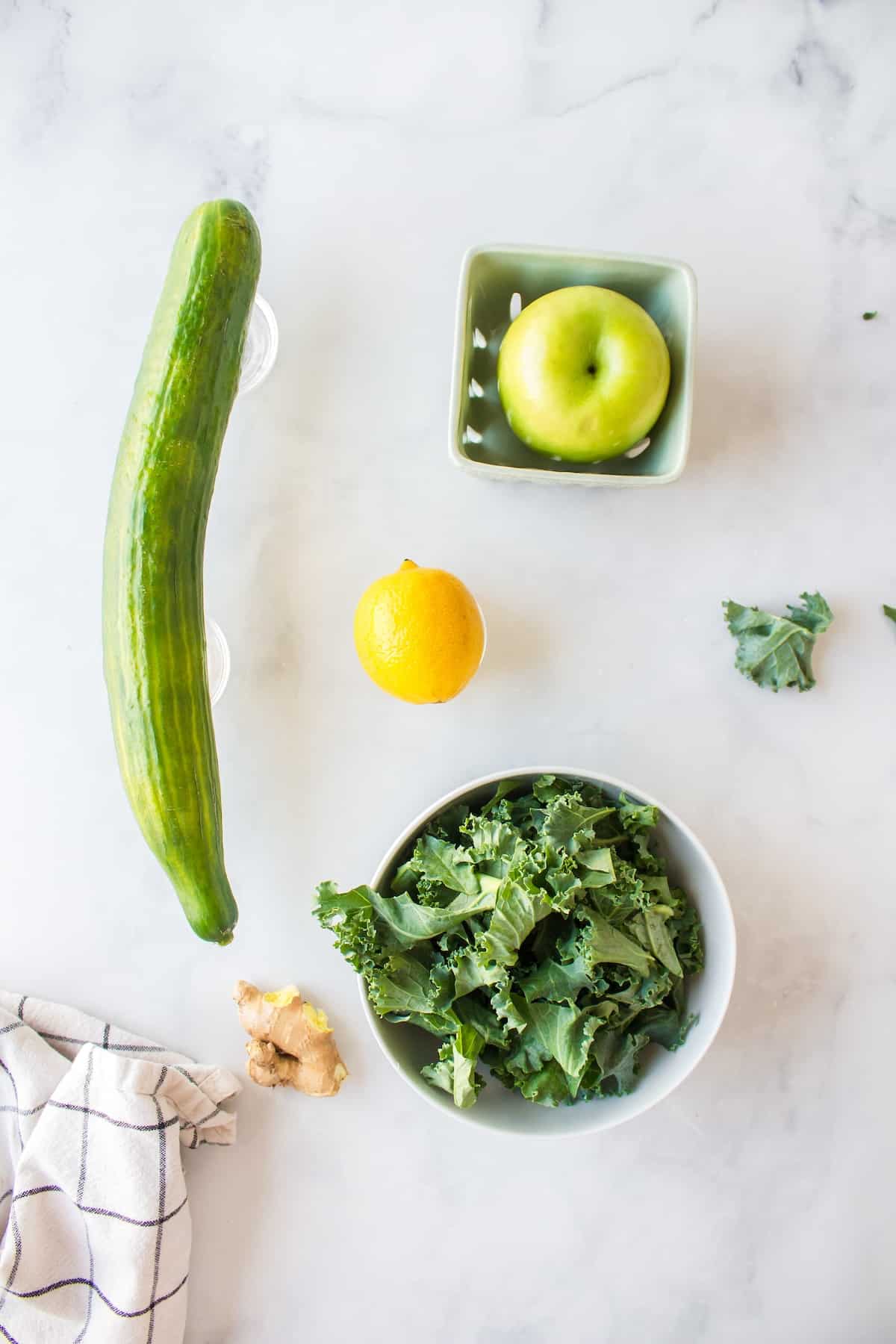 ingredients for making kale juice on table.