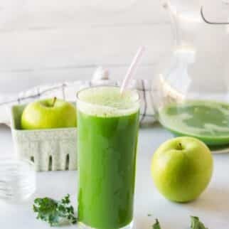 kale juice served in glass on table.