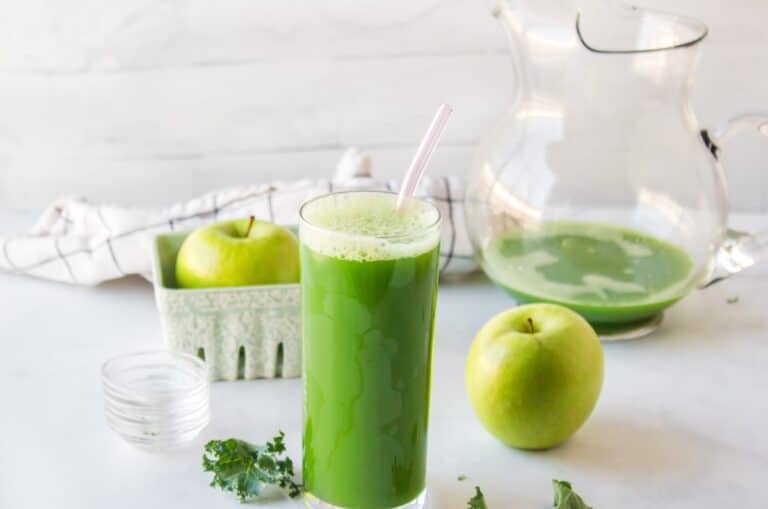 kale juice served in glass on table.