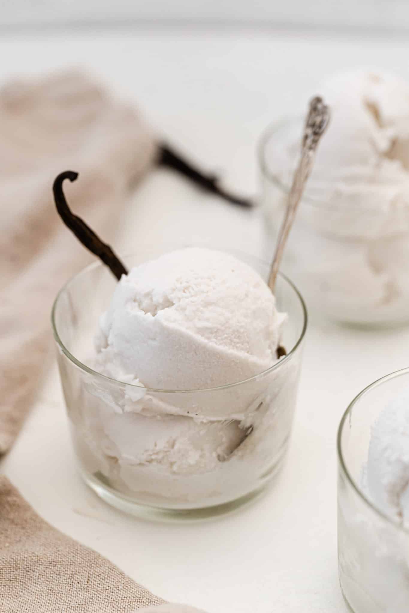 Homemade Vitamix ice cream with vanilla bean in a glass cup.