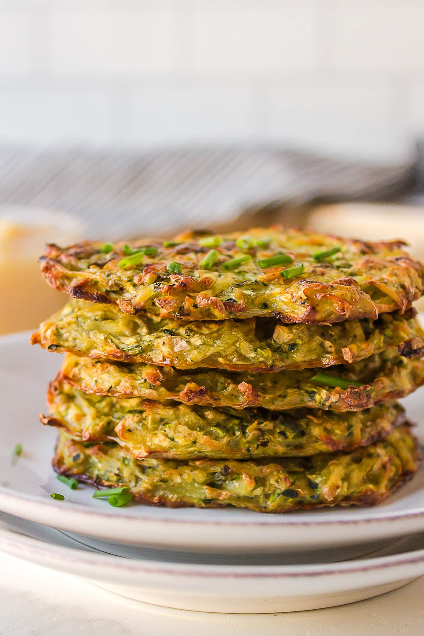 stack of zucchini fritters on a plate.