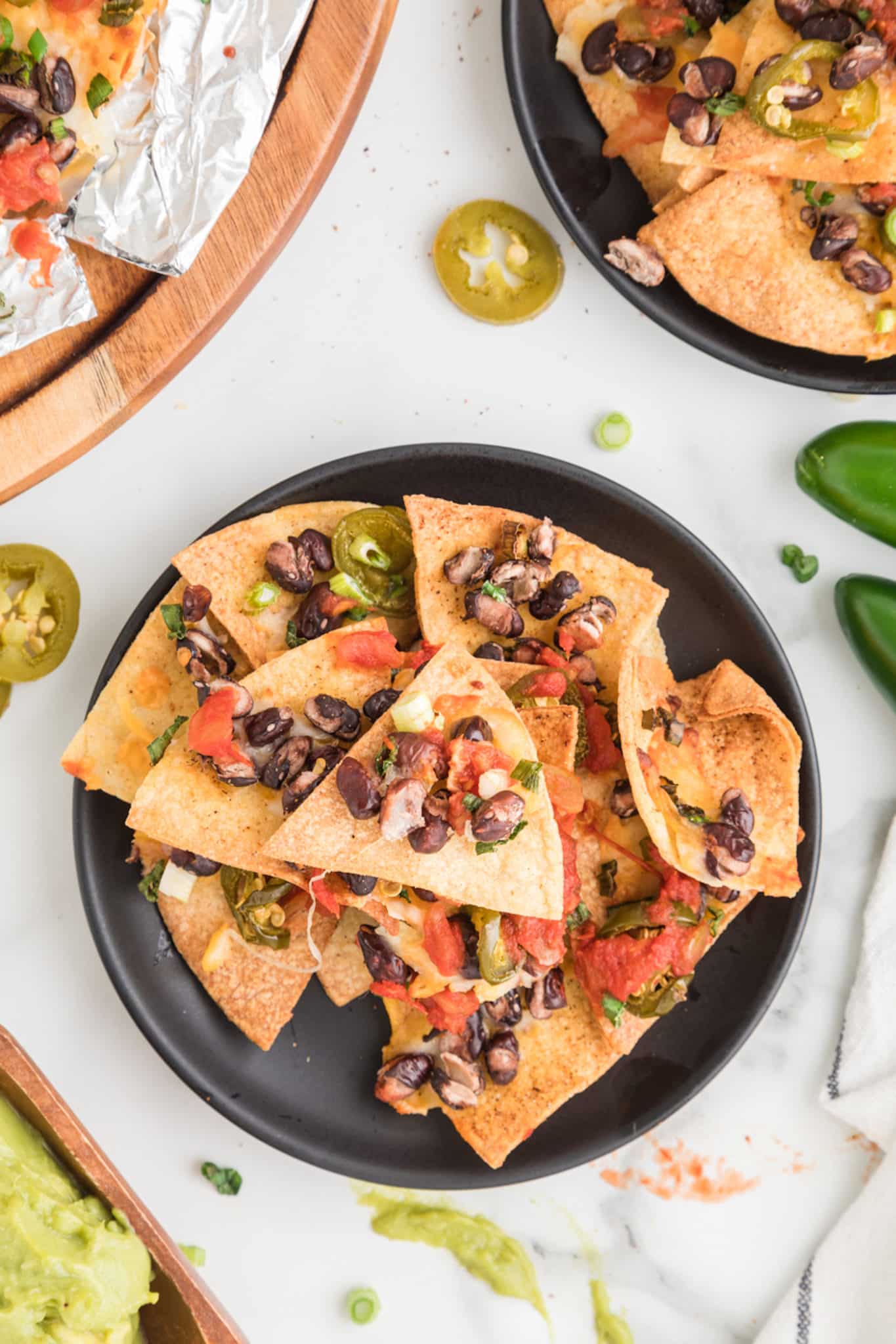 air fried nachos with beans and salsa on a plate.