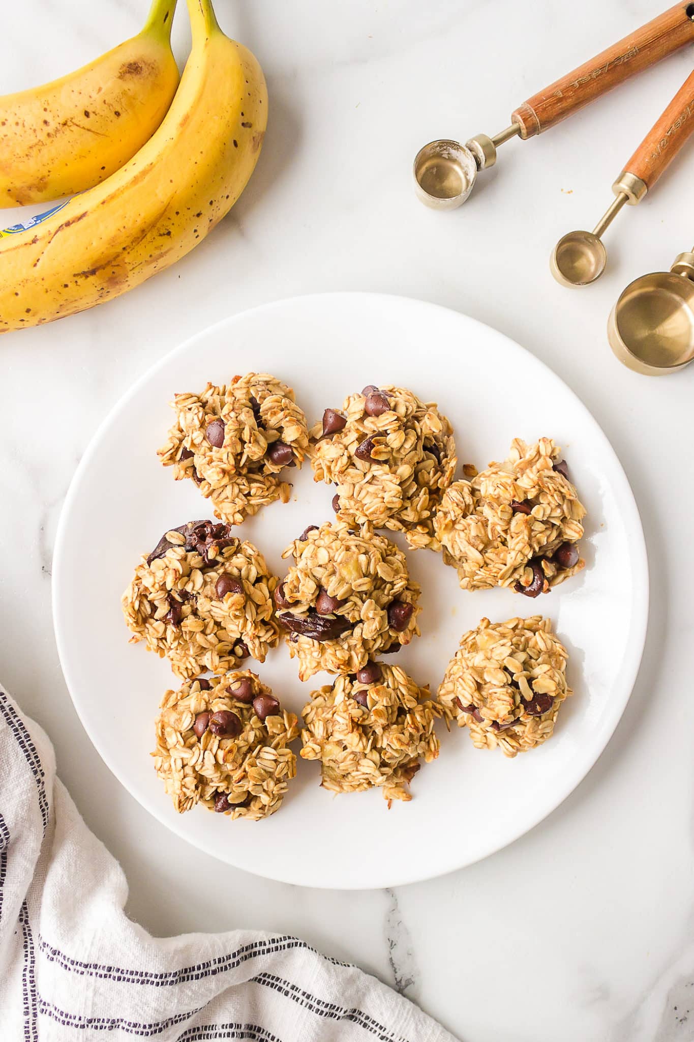 Top view of a white dinner plate filled with vegan banana oat cookies.