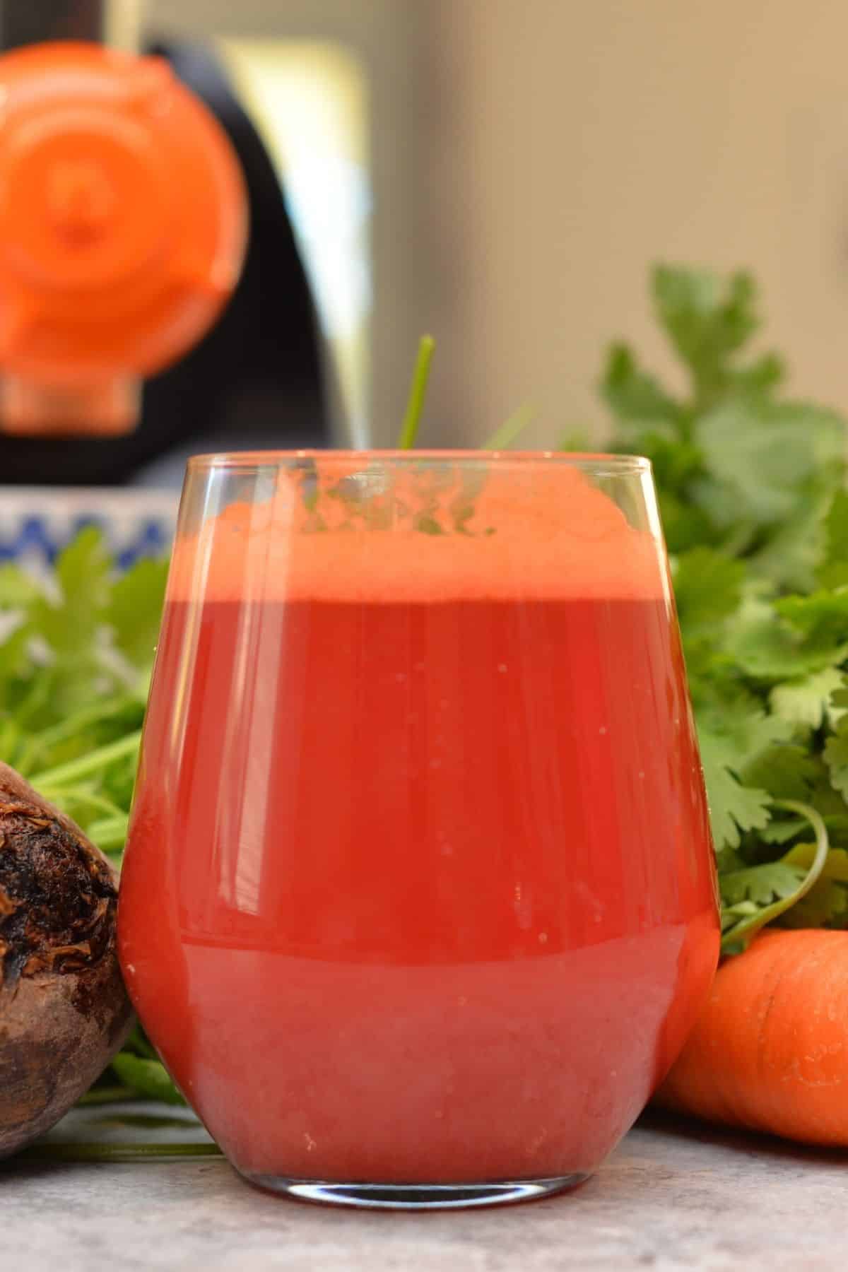 glass of beet carrot juice on table.