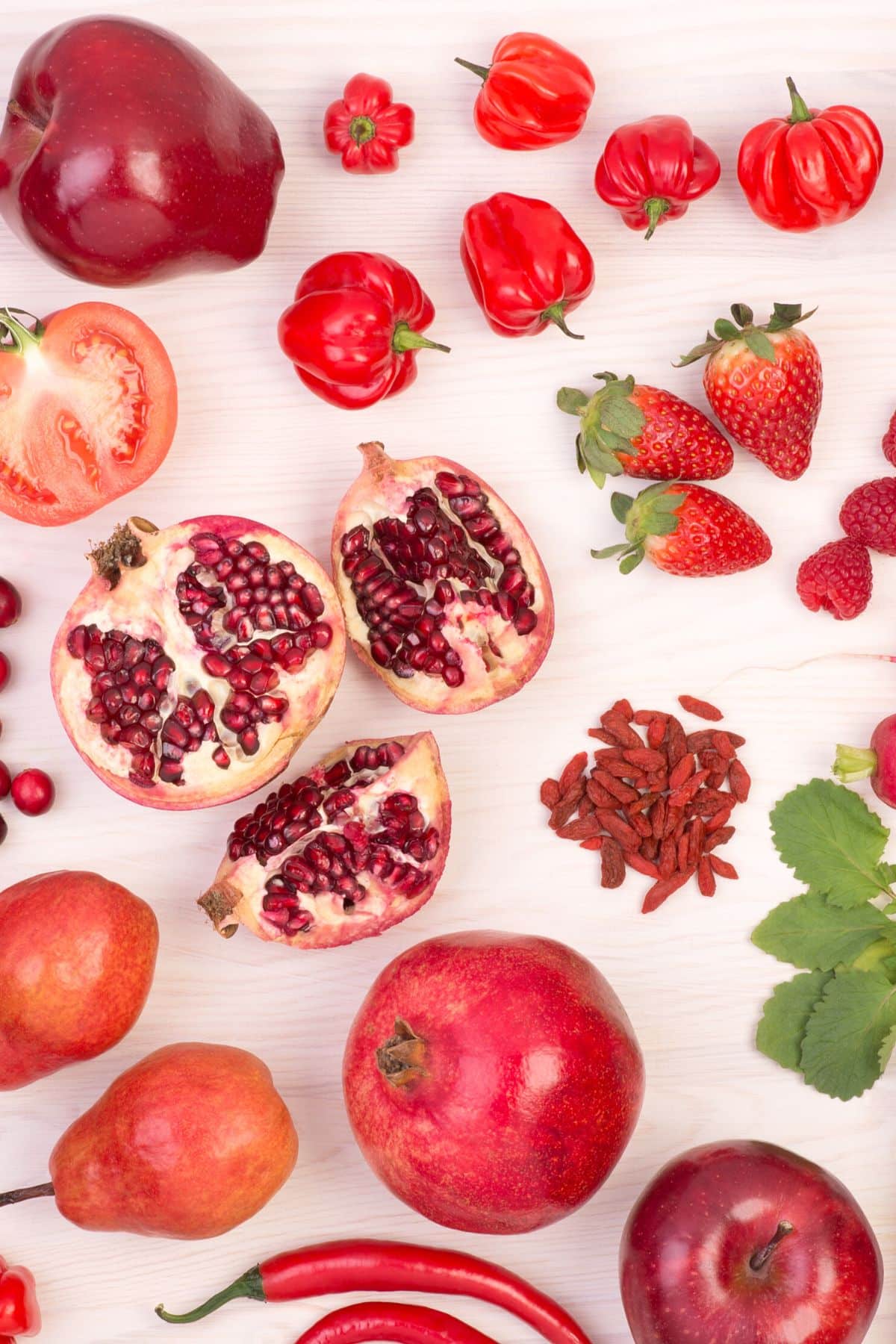 Some of the best red fruits placed on a wooden table.