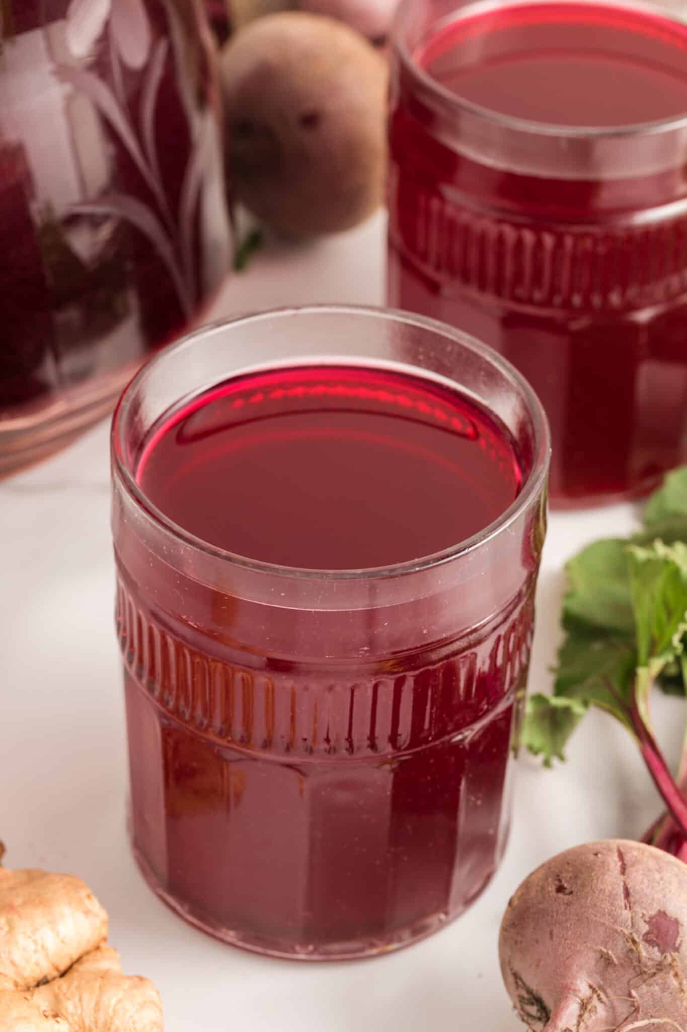 glass of homemade beet juice on table.