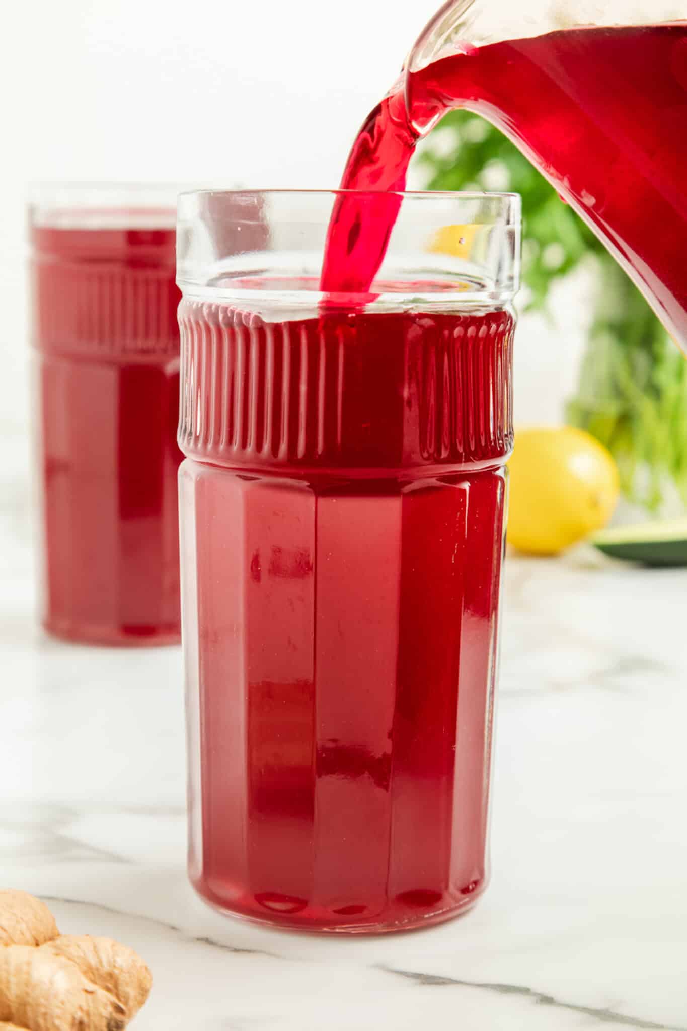 pouring beet juice into glass.