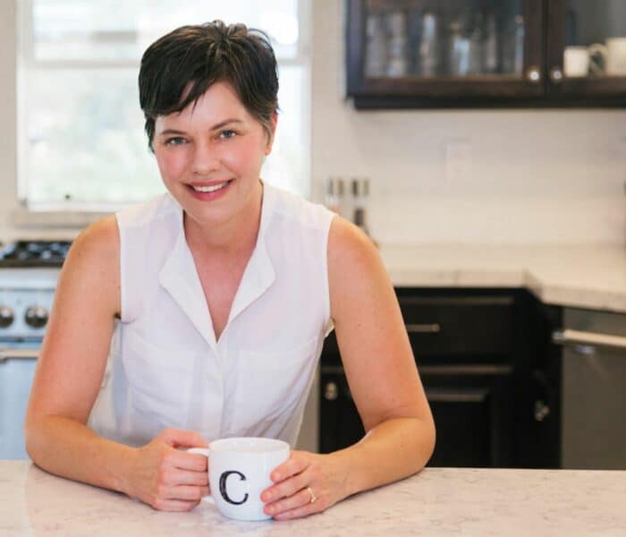 carrie in kitchen with mug.