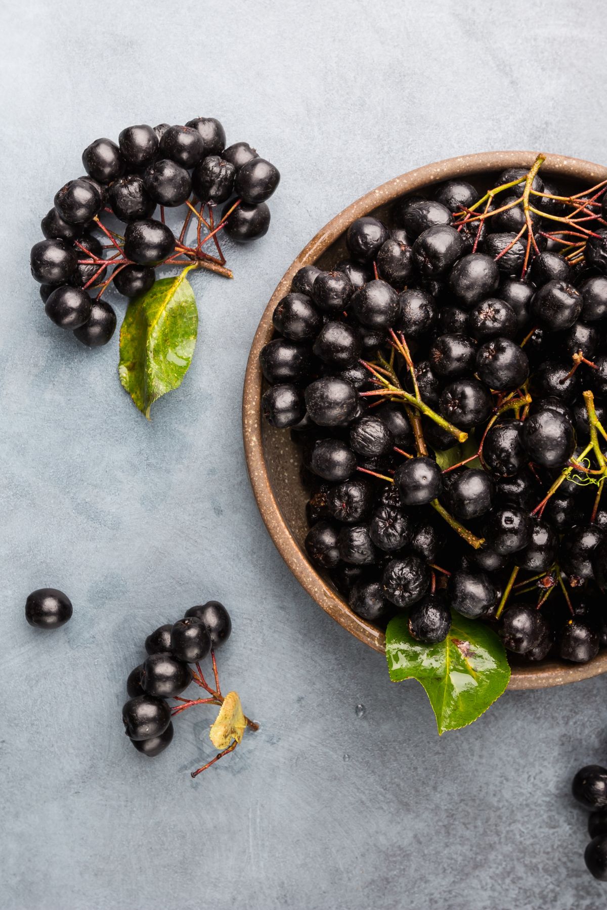 chokeberries in a wooden bowl.