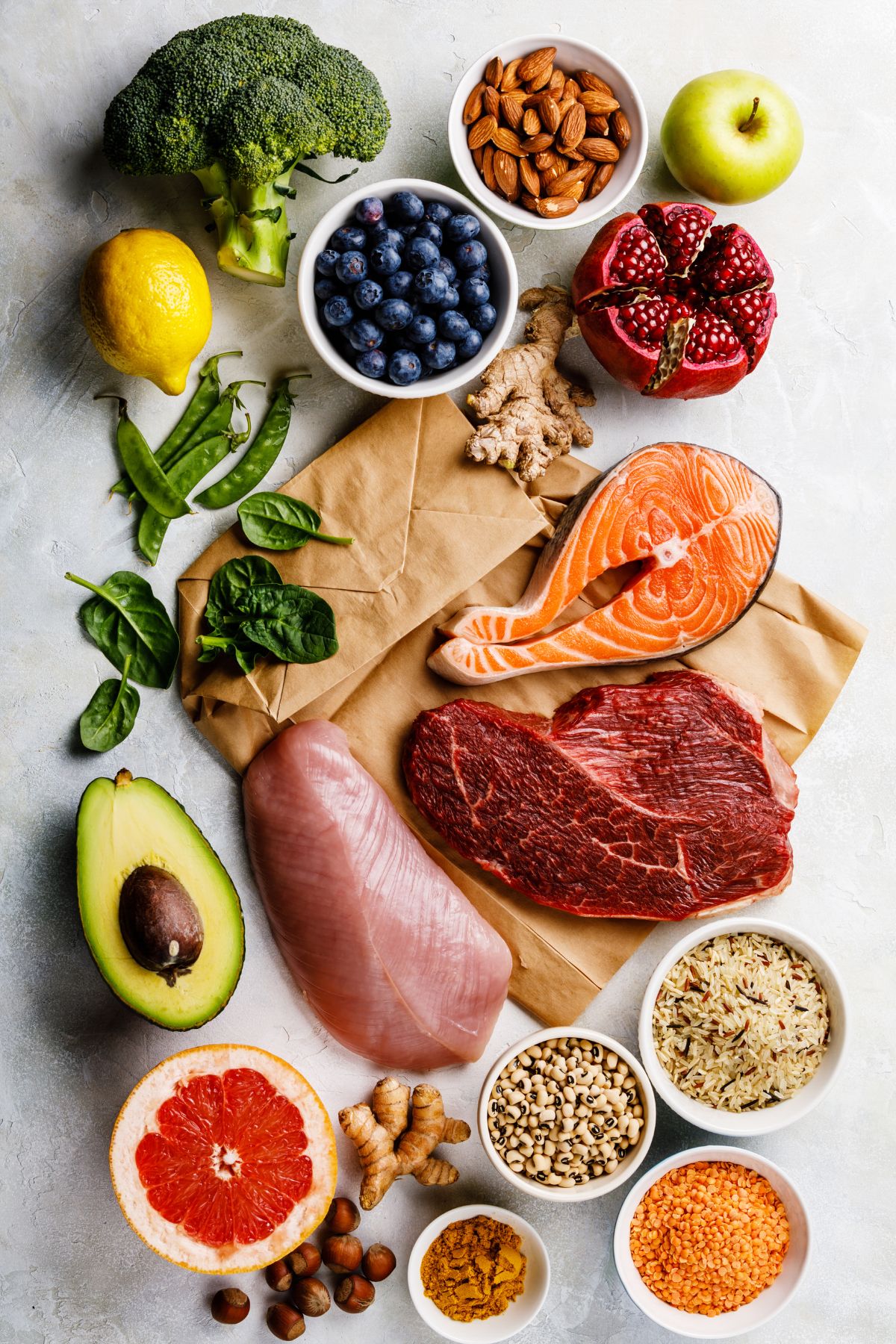 selection of healthy foods on table with brown grocery bag.