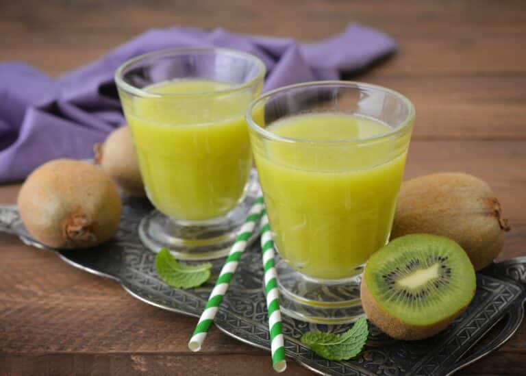 Two short glasses of freshly squeezed kiwi juice.