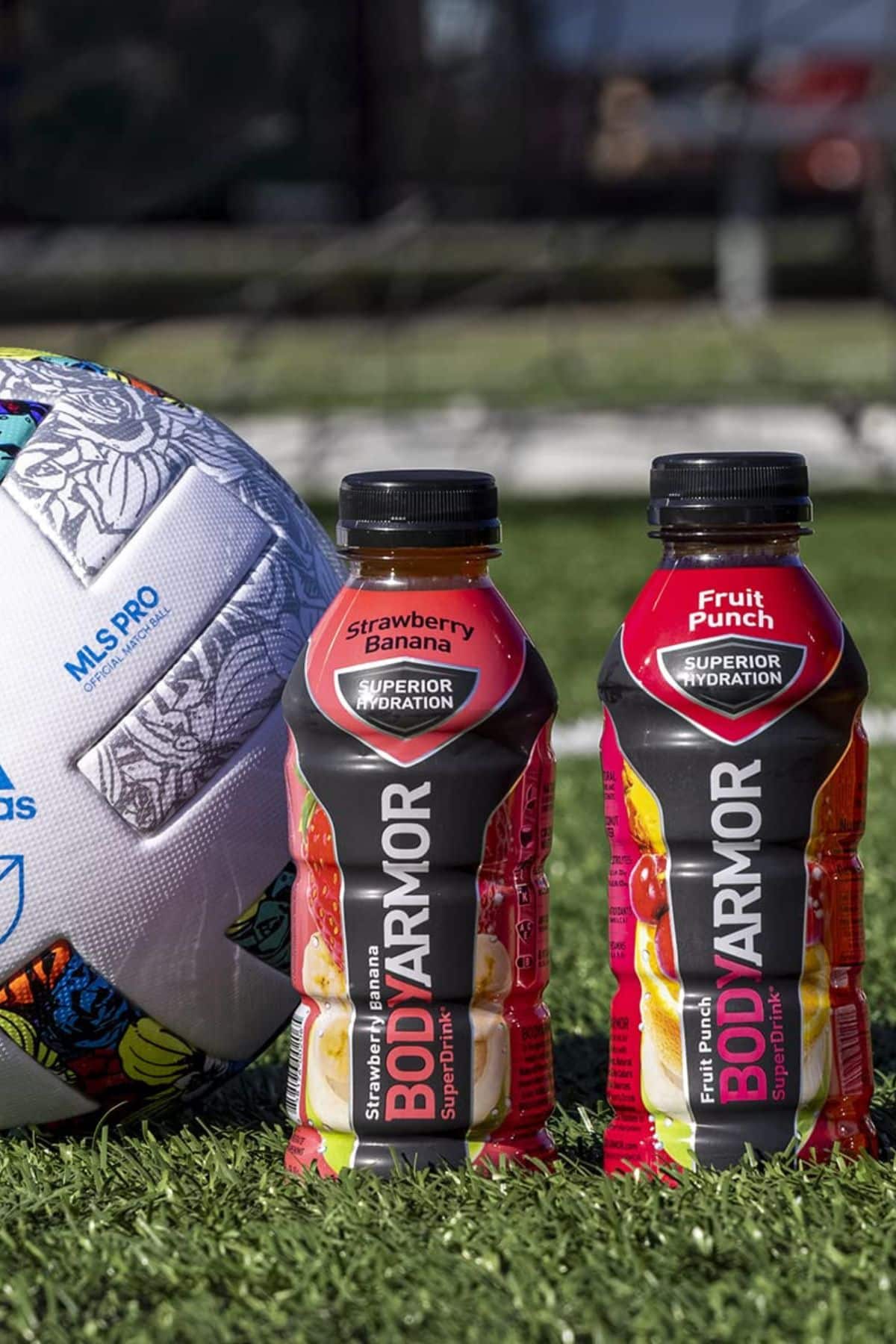 two bottles of Body Armor next to a volleyball.