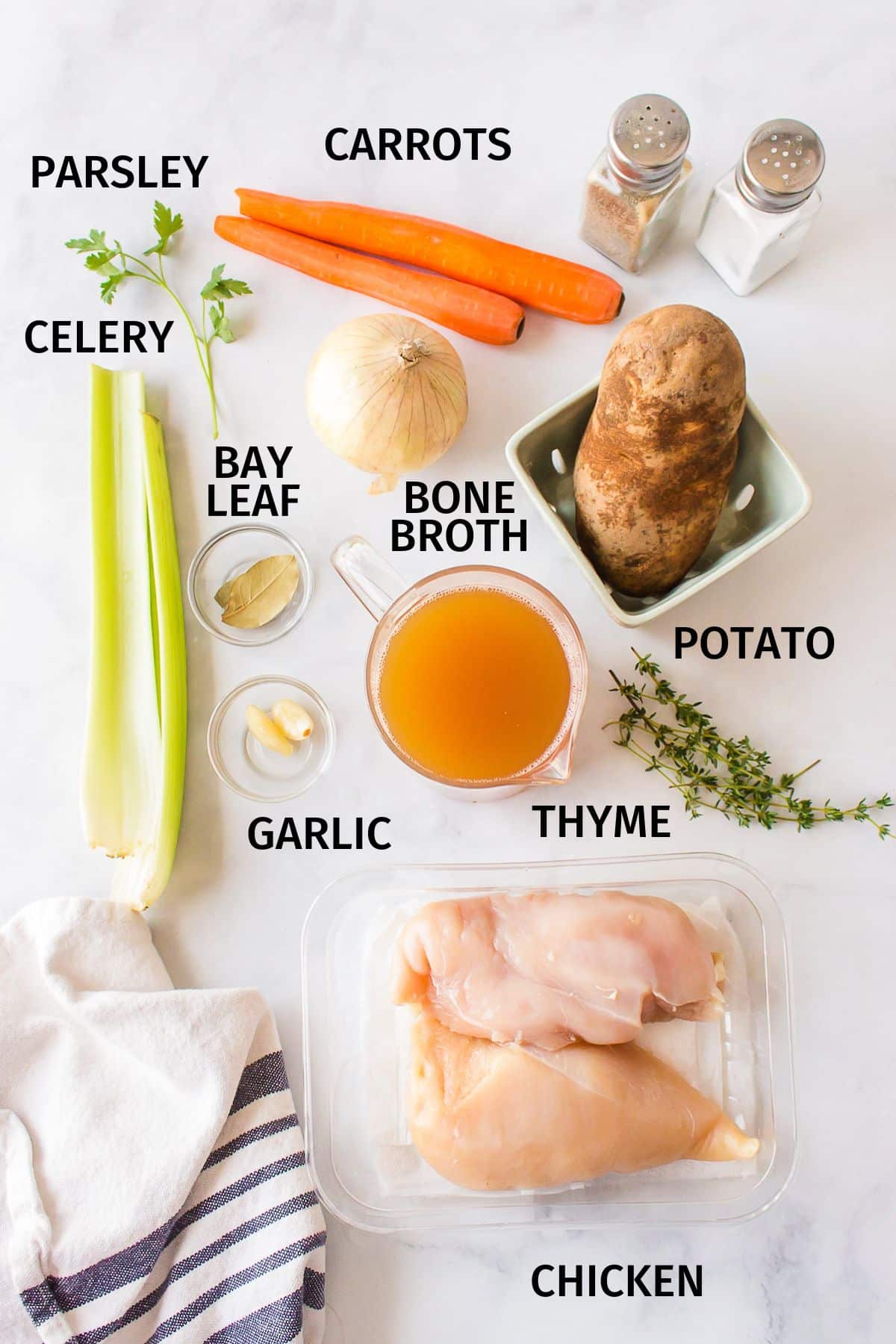 ingredients needed for bone broth chicken soup on a counter.