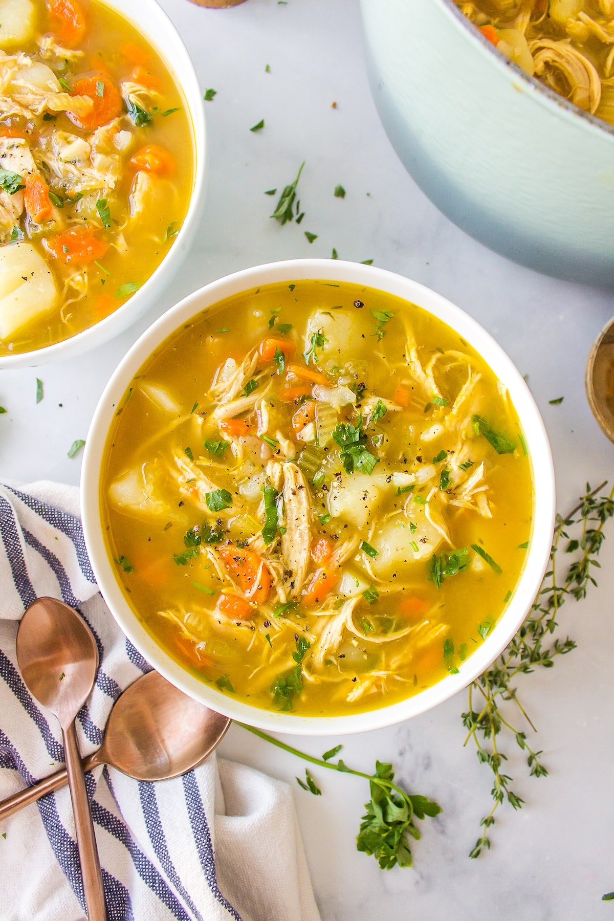 two bowls of bone broth chicken soup.