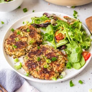 gluten-free salmon cakes on a white plate with salad.