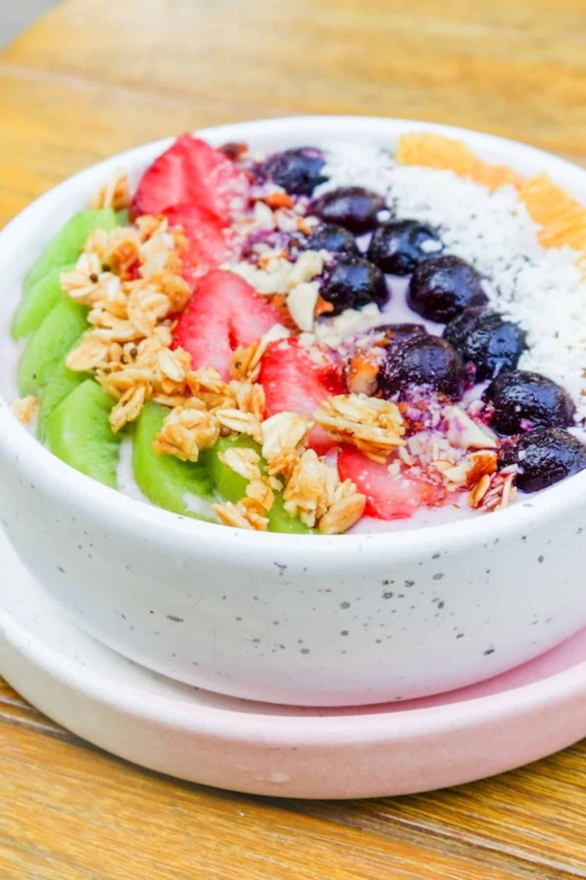 pretty bowl with smoothie and toppings.