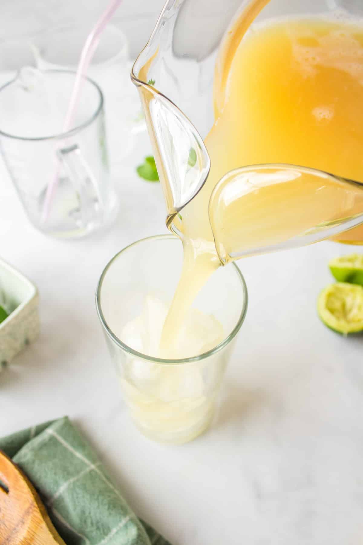 pouring pineapple juice mixture into glass.