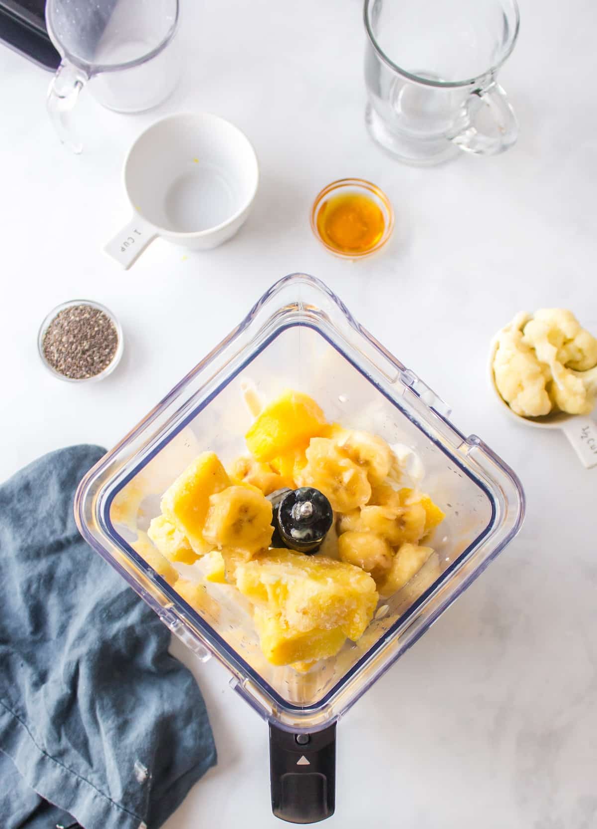 ingredients for pineapple smoothie in blender.