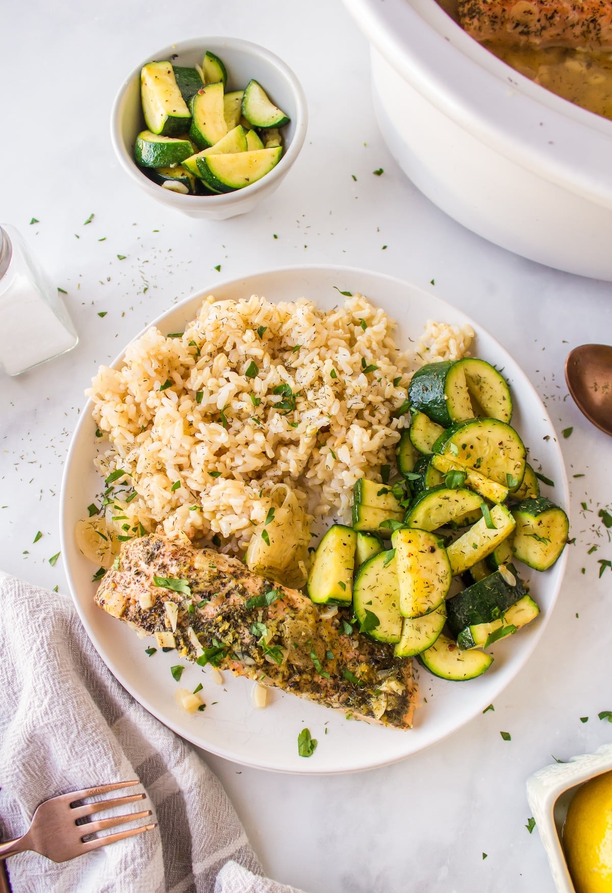 slow cooker salmon served on plate with rice and veggies.